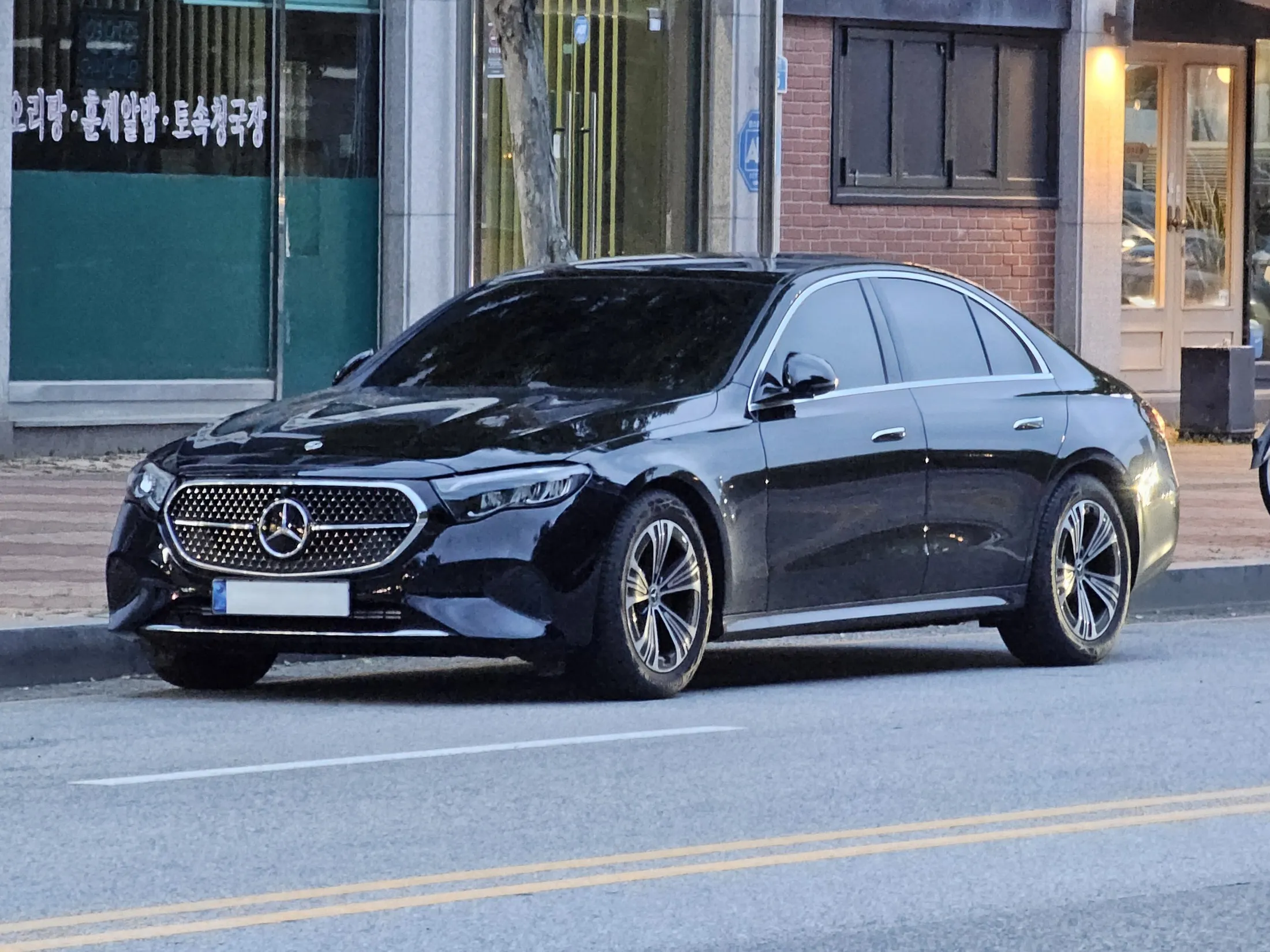 A black Mercedes-Benz E-Class saloon