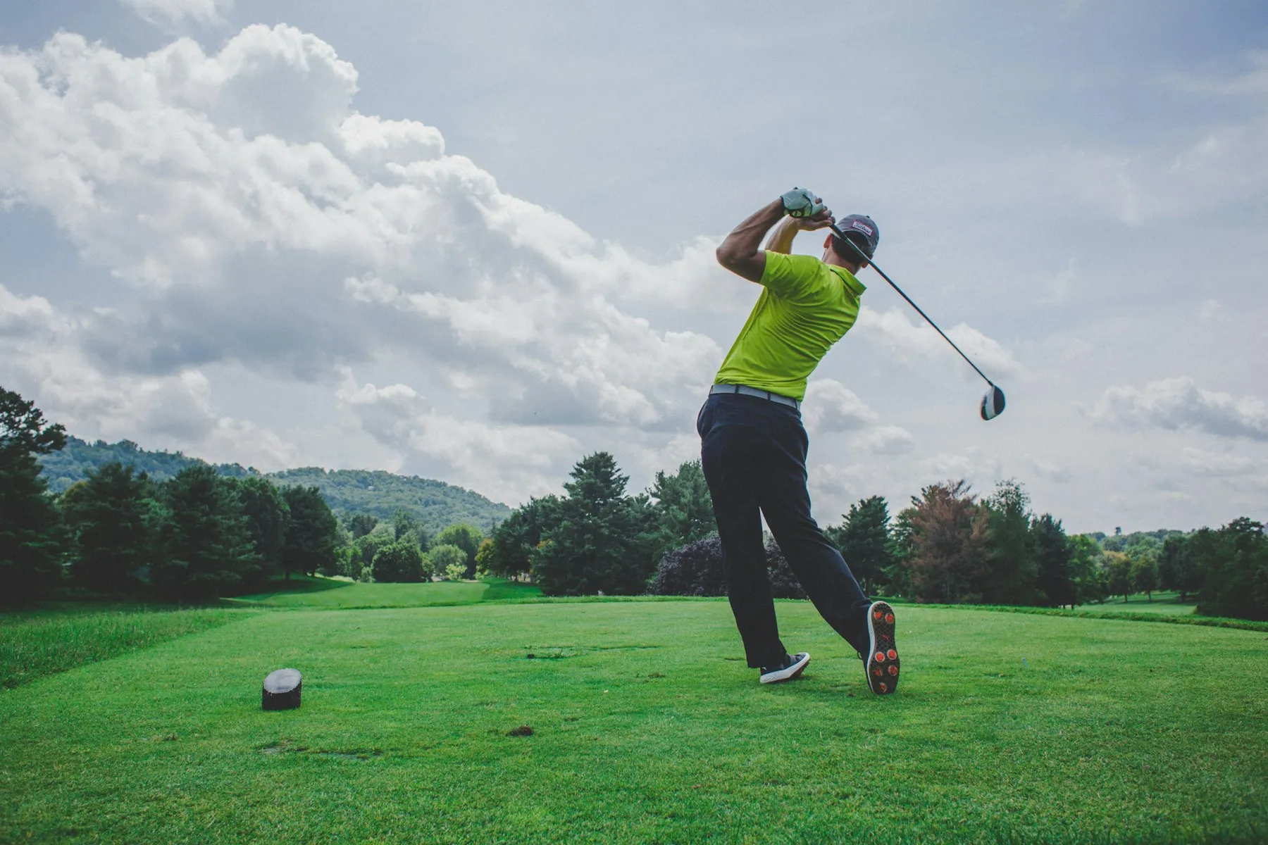 A golfer teeing off